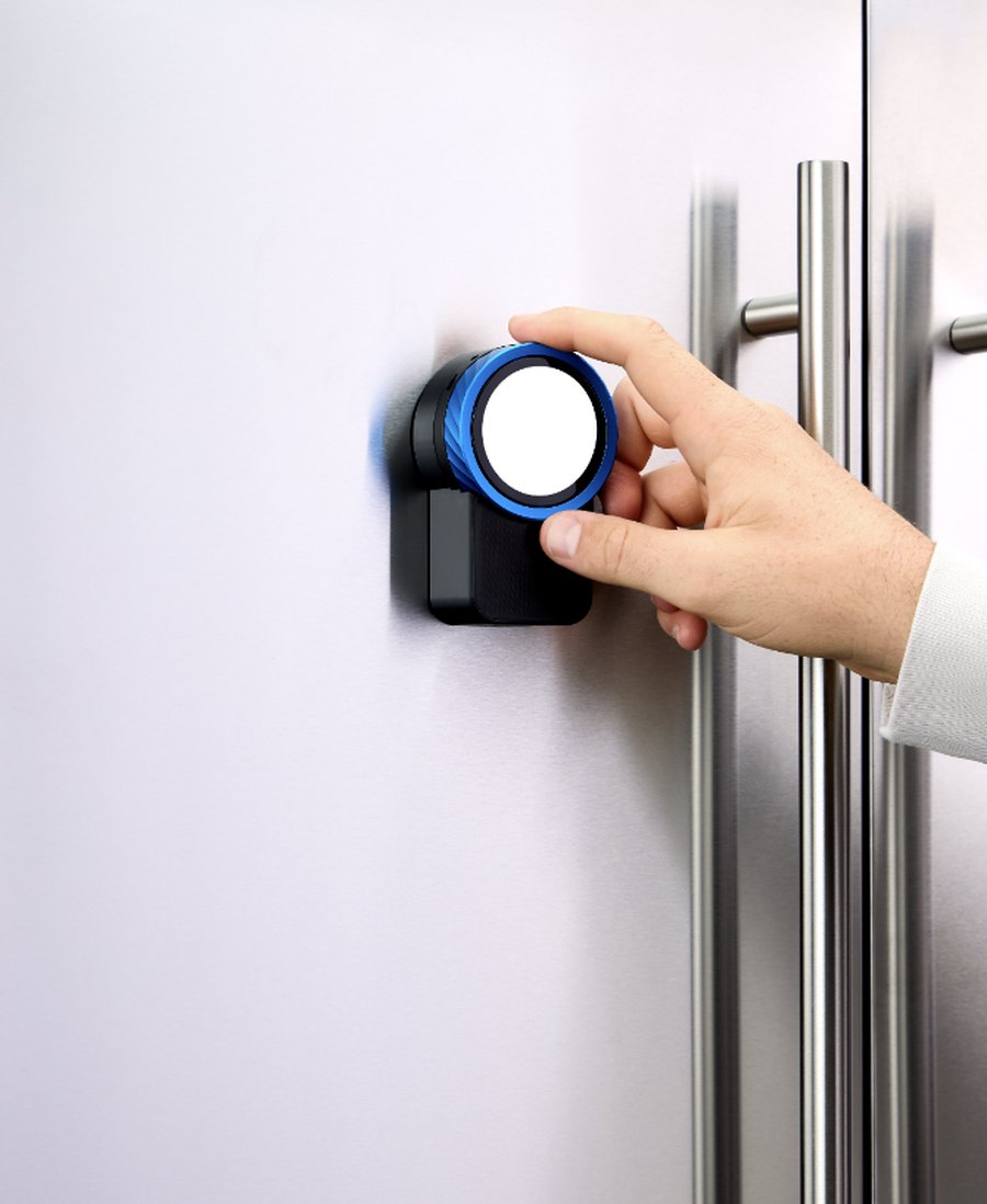 The Trepo device magnetised to a fridge door